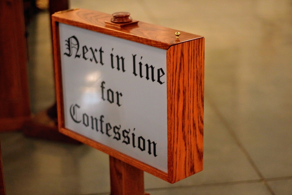 sign saying next in line for confession